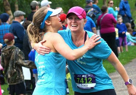 One MOTR member hugging another at a race