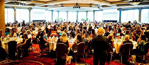 100s of Members of Moms on the Run in a banquet room celebrating our signature training program