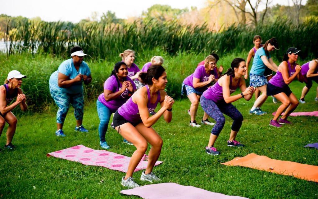 MOTR members squatting next to yoga mats