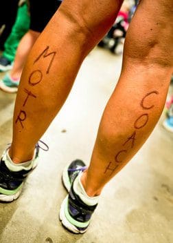 Legs with marker that says MOTR Coach