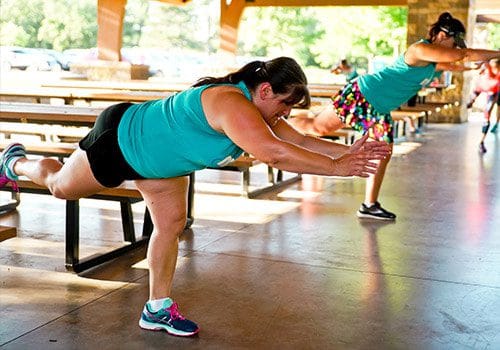 MOTR Coon Rapids member completing exercises balanced on a picnic table