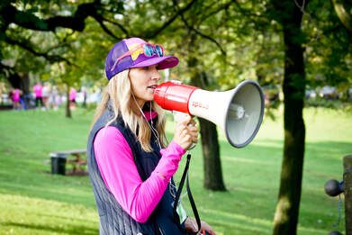 Olympian Carrie Tollefson with a megaphone at the annual MOTR 5K/10K/Kids Race