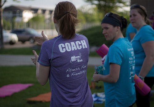 Image of woman wearing a COACH shirt