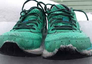 green running shoes in snow