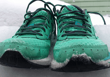 green running shoes in snow