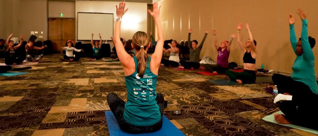 A group of MOTR members on yoga mats, stretching.