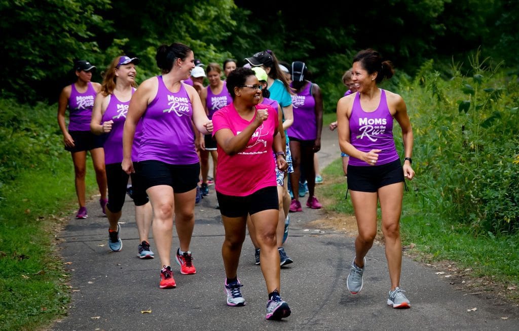 Group of MOTR members running, walking and smiling