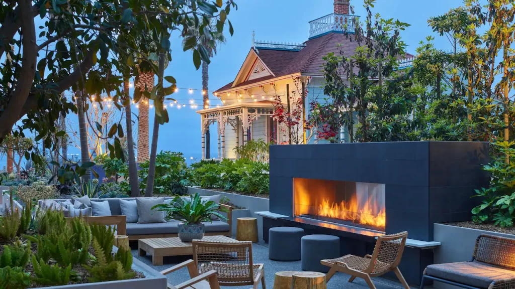 Image of destination race - california - patio. Includes a fireplace, sofas, chairs and twinkle lights