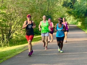 Shoreview Moms on the Run running on a path in a group