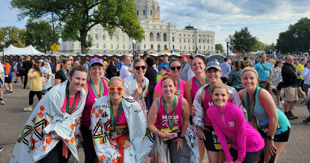 Woodbury Moms on the Run in front of the Capitol with their franchise owner