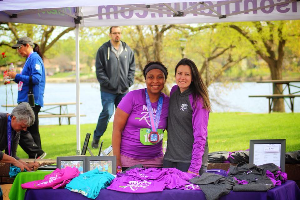 Karissa Johnson and MOTR member standing under a MOTR-branded tent at an event