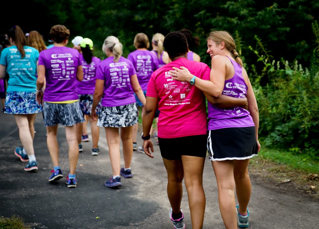 One MOTR member with her arm around another