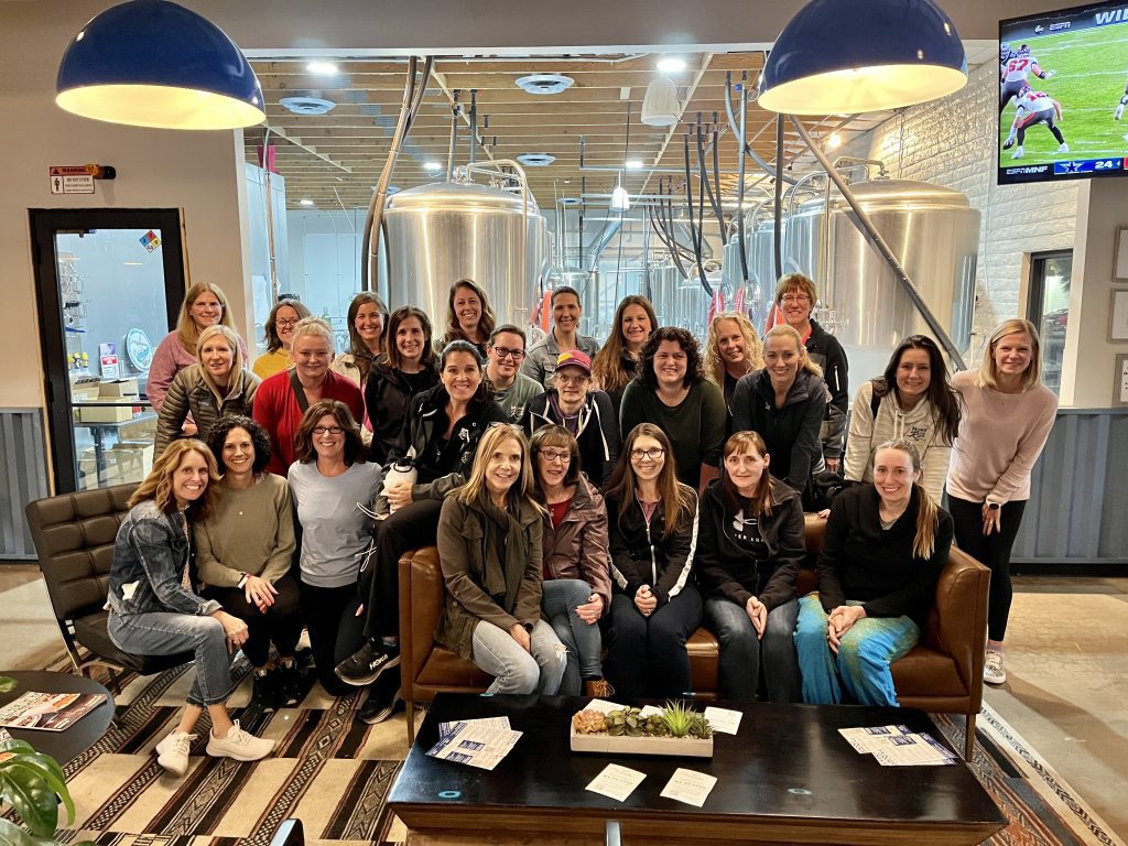 group of women standing in a restaurant at a destination race weekend
