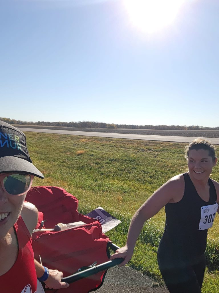 Two runners pulling jogging stroller