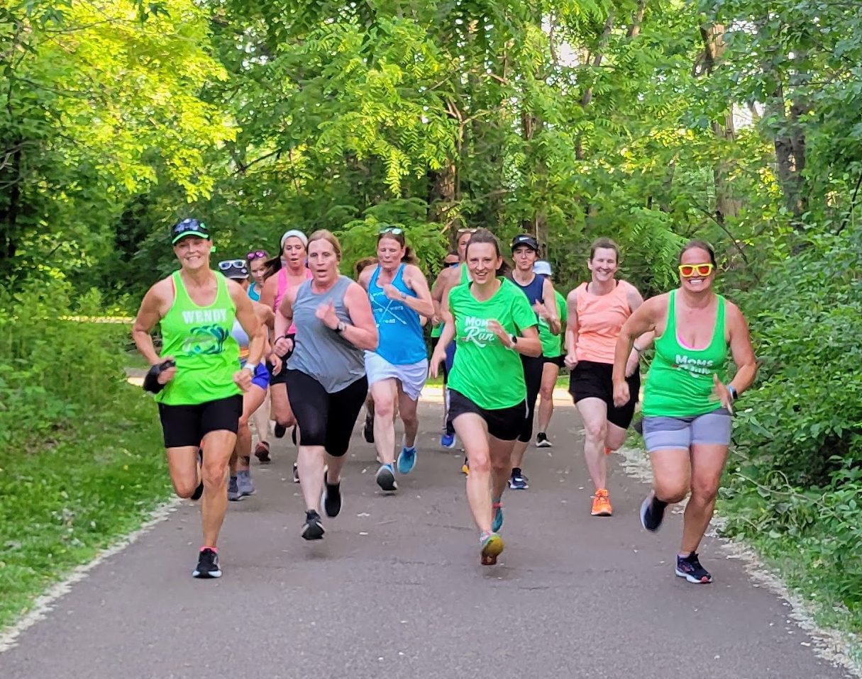 A group of MOTR runners on a wooded path. They're likely training for 5Ks, 10K, half-marathons and full marathons