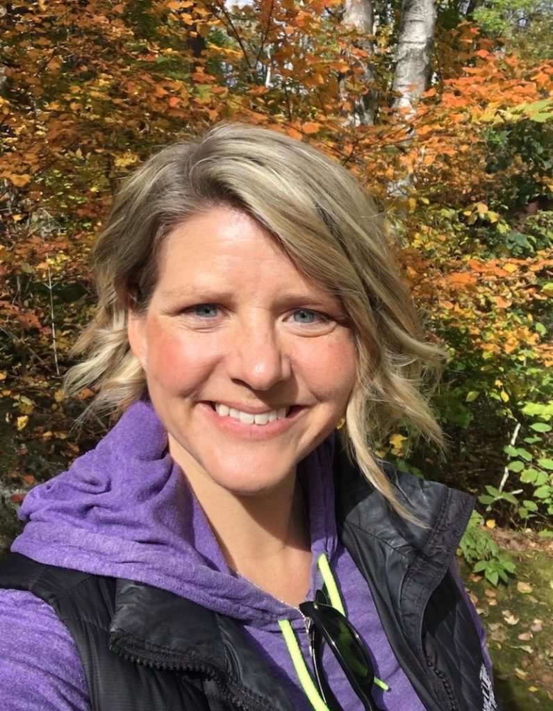 Heather, from Pine City Moms on the Run standing by a tree