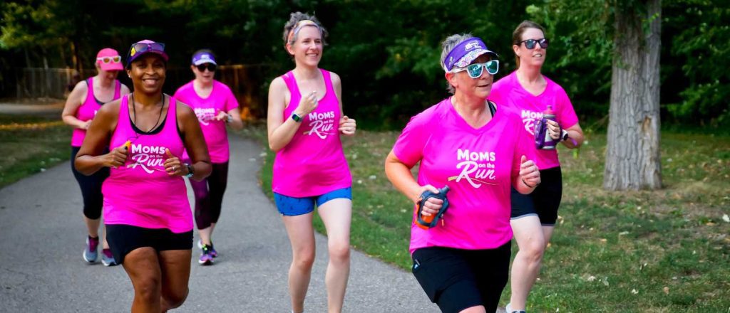 7 MOTR members running on a path wearing pink MOTR shirts
