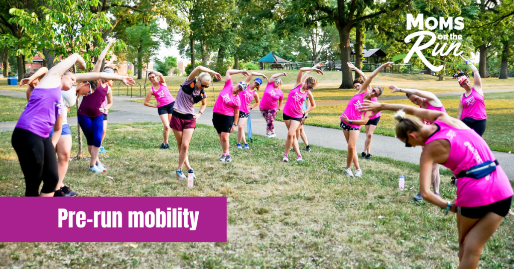 Runners in pink shirts stretching