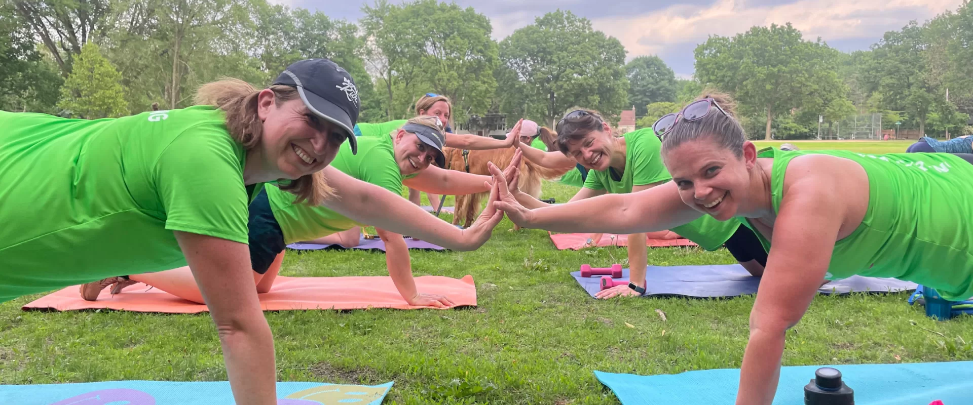 Women in planks high diving in green Moms on the Run tanks