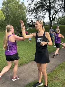 Carrie giving a high five at the MOTR race