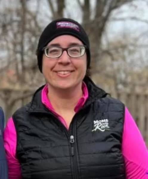 Coach Megan in Bloomington wearing a headband and vest