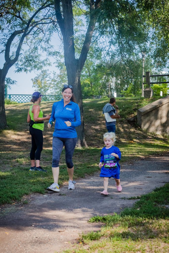 Mom runner with daughter at race