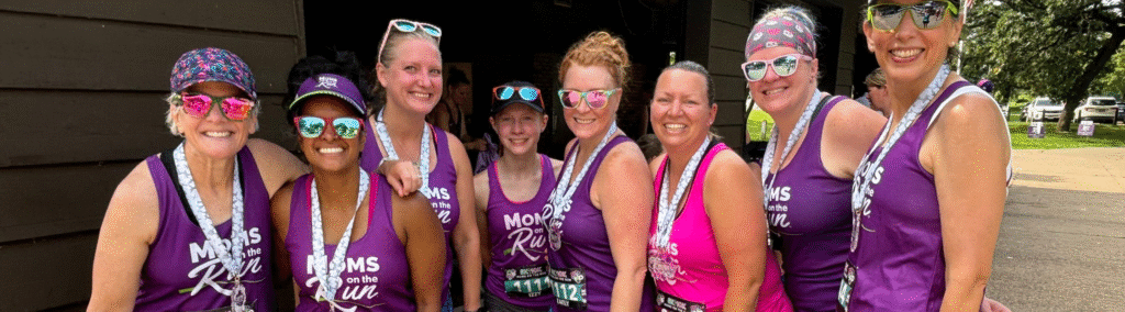 female runners in colorful shirts with medals