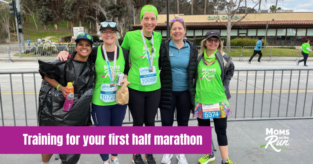 runners wearing bright green shirts at finish line with medals