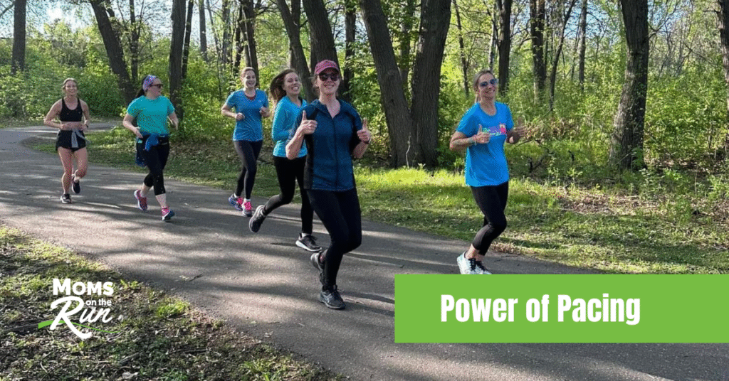 women running on paved trail through woods