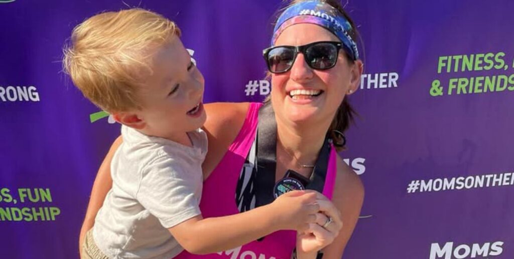 Runner hugging toddler