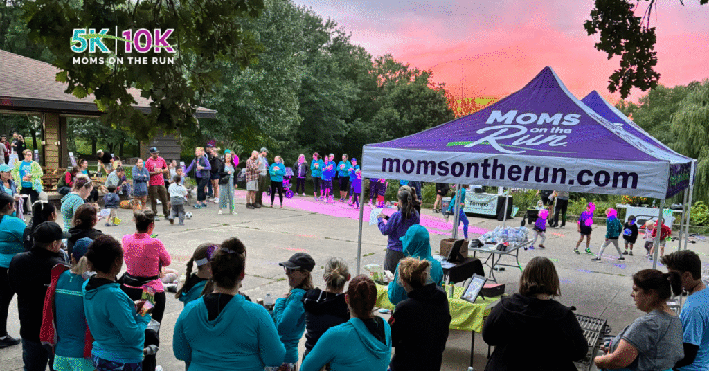 large group with tent and sunset