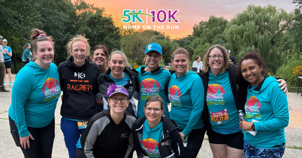 runners in teal shirts with sunset