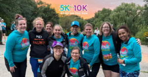 runners in teal shirts with sunset