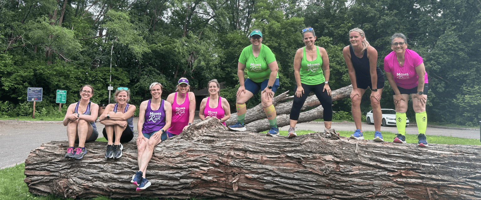 women runners on tree log