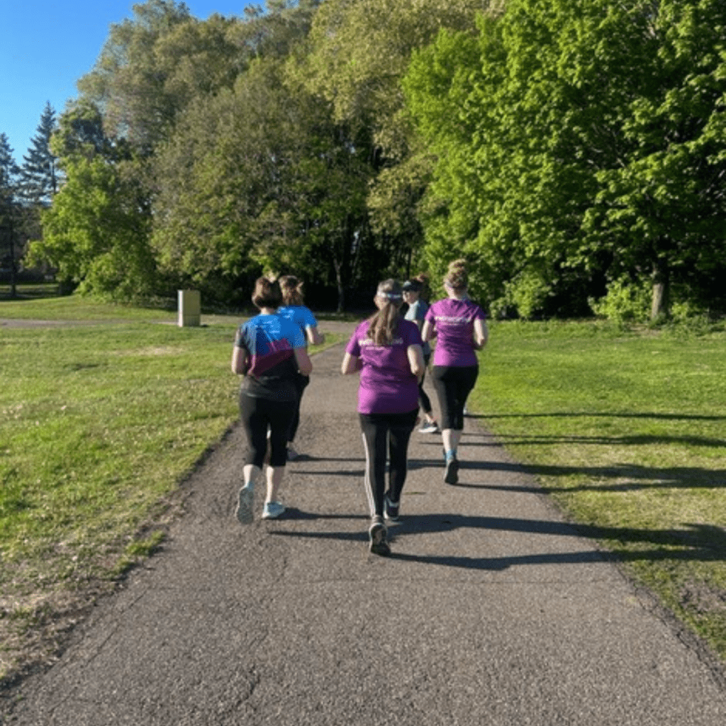 three women on trail running away